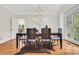 Elegant dining room featuring hardwood floors, large windows, and modern chandelier at 820 Thermopylae Ct, Alpharetta, GA 30005