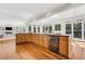 Open kitchen with a large island, lots of cabinets, stainless steel appliances, and hardwood floors at 820 Thermopylae Ct, Alpharetta, GA 30005