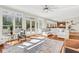 Bright living room boasts hardwood floors, large windows, and a white couch for comfortable seating at 820 Thermopylae Ct, Alpharetta, GA 30005