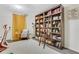 Cozy living area featuring a large bookcase with ladder, comfortable seating, and natural light at 820 Thermopylae Ct, Alpharetta, GA 30005