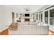 Bright living room featuring a cozy sofa, built-in shelving, and a stone fireplace at 820 Thermopylae Ct, Alpharetta, GA 30005