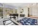 Sunlit living room with hardwood floors, and a cozy sitting area by a bank of large windows at 820 Thermopylae Ct, Alpharetta, GA 30005