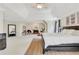 Bright main bedroom boasts tray ceilings, fireplace, and decor at 820 Thermopylae Ct, Alpharetta, GA 30005