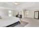 Large main bedroom with tray ceiling, neutral carpet, and exterior access at 820 Thermopylae Ct, Alpharetta, GA 30005