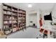 This office space has a large bookcase with a ladder and a comfortable work area with a computer at 820 Thermopylae Ct, Alpharetta, GA 30005