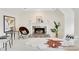 Cozy sitting room with fireplace, unique seating, and neutral colors at 820 Thermopylae Ct, Alpharetta, GA 30005