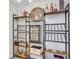 This wine room features shelving, a wine cooler, wooden accents, and stylish decor at 820 Thermopylae Ct, Alpharetta, GA 30005