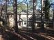 Rear exterior view of the home highlighting the screened porch area and backyard at 9165 Eves Cir, Roswell, GA 30076