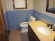 Half bathroom showcasing blue wainscoting, granite countertop, and modern fixtures at 9165 Eves Cir, Roswell, GA 30076