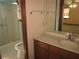 Bathroom features a single sink vanity, large mirror, and a shower enclosed by a glass door at 9165 Eves Cir, Roswell, GA 30076