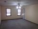 Large bedroom with dual windows, a ceiling fan, neutral walls and carpet, and white trim at 9165 Eves Cir, Roswell, GA 30076