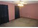Standard-sized bedroom with neutral carpet, ceiling fan, and a pair of dark curtains at 9165 Eves Cir, Roswell, GA 30076
