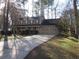 Traditional home with a spacious three-car garage and a long driveway at 9165 Eves Cir, Roswell, GA 30076