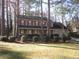 Charming two-story traditional home with a manicured lawn and mature landscaping at 9165 Eves Cir, Roswell, GA 30076