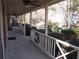 Covered front porch with white railing and ceiling fans at 9165 Eves Cir, Roswell, GA 30076