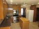 Well-lit kitchen featuring wood cabinetry, stainless steel appliances, and a convenient center island at 9165 Eves Cir, Roswell, GA 30076