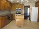 Spacious kitchen with stainless steel appliances, wood cabinets, and center island at 9165 Eves Cir, Roswell, GA 30076