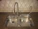 Close-up of a modern stainless steel kitchen sink with a granite countertop at 9165 Eves Cir, Roswell, GA 30076