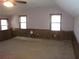 Spacious living room featuring paneled walls, two windows, and neutral carpet at 9165 Eves Cir, Roswell, GA 30076