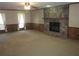 Spacious living room with a stone fireplace and carpet at 9165 Eves Cir, Roswell, GA 30076