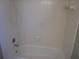 Bathroom featuring a shower with white tiles, a standard shower head, and shower fixtures at 9165 Eves Cir, Roswell, GA 30076