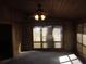 Cozy sunroom featuring wood paneling, natural light, and neutral carpeting at 9165 Eves Cir, Roswell, GA 30076