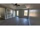 Large bedroom showcasing hardwood floors, neutral paint, tray ceilings, ceiling fan, and a modern sliding door at 4271 Winston Cir, South Fulton, GA 30349