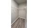 Walk-in closet features hardwood floors, white trim, and metal storage shelves at 4271 Winston Cir, South Fulton, GA 30349