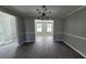 Dining room with unique light fixture features gray walls with wood-look floors and crown molding at 4271 Winston Cir, South Fulton, GA 30349