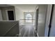 Upstairs hallway features a decorative chandelier, luxury vinyl plank flooring, and neutral paint at 4271 Winston Cir, South Fulton, GA 30349