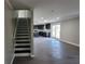 Open-concept living room features luxury vinyl plank flooring, stairs and a view of the kitchen at 4271 Winston Cir, South Fulton, GA 30349