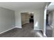 Bright living room with gray walls and wood-look floors that lead to dining and entry at 4271 Winston Cir, South Fulton, GA 30349