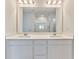 Bathroom featuring double sinks, quartz countertops, and large mirror at 650 Cayenne Way, Lawrenceville, GA 30045