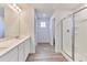 Modern bathroom featuring double sinks, a large shower, and wood-style flooring at 650 Cayenne Way, Lawrenceville, GA 30045