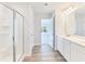Bright bathroom with double sinks, walk-in shower, and wood-style flooring at 650 Cayenne Way, Lawrenceville, GA 30045