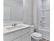 A pristine bathroom features a vanity and a shower over tub combination, all in white at 650 Cayenne Way, Lawrenceville, GA 30045