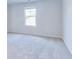 Light-filled bedroom featuring a large window and neutral carpeting at 650 Cayenne Way, Lawrenceville, GA 30045