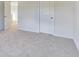 Light-filled bedroom with neutral carpet, featuring a closet and bathroom access at 650 Cayenne Way, Lawrenceville, GA 30045