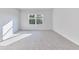 Sunlit bedroom with plush carpeting and a large window at 650 Cayenne Way, Lawrenceville, GA 30045