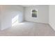 The bedroom has grey carpet and white walls with a bright window at 650 Cayenne Way, Lawrenceville, GA 30045