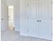 A bedroom with closet space and a door leading to an upstairs hallway is carpeted at 650 Cayenne Way, Lawrenceville, GA 30045