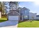 Charming two-story home with a well-manicured lawn, attached two-car garage, and welcoming curb appeal at 650 Cayenne Way, Lawrenceville, GA 30045