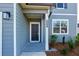 Welcoming front entrance with a black door, manicured landscaping, and gray siding at 650 Cayenne Way, Lawrenceville, GA 30045