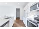 An updated kitchen with stainless appliances, granite counters, white cabinets, and wood floors at 650 Cayenne Way, Lawrenceville, GA 30045