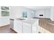 Open-concept kitchen with island, stainless steel appliances, and view to the living room with an electric fireplace at 650 Cayenne Way, Lawrenceville, GA 30045