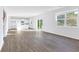 Open-concept living area with hardwood floors, bright windows, and an eat-in kitchen in the background at 650 Cayenne Way, Lawrenceville, GA 30045