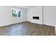 Modern living room with sleek floors, large window, and cozy electric fireplace at 650 Cayenne Way, Lawrenceville, GA 30045
