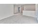 Upstairs loft area with white walls, neutral carpet, and doors to other bedrooms at 650 Cayenne Way, Lawrenceville, GA 30045