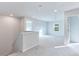Spacious, sunlit loft area with neutral carpet, white walls, and easy access to other rooms at 650 Cayenne Way, Lawrenceville, GA 30045
