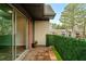 Private balcony with tiled flooring, sliding glass doors, and a privacy screen with greenery at 6851 Roswell Rd # N10, Sandy Springs, GA 30328